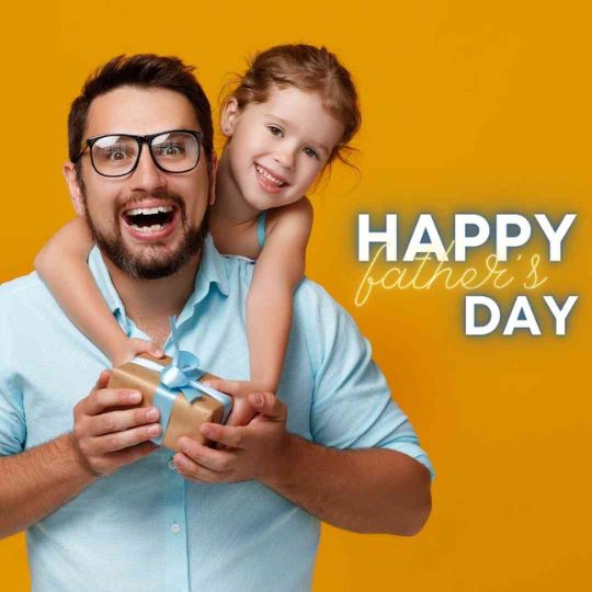 a Man with Glasses and a Beard, Smiling Widely, is Being Hugged from Behind by a Young Girl with Light Brown Hair. They Are Both Holding a Small Gift Wrapped with a Blue Ribbon. the Background is a Solid Yellow Color with the Text "happy Father's DAY" in white font.