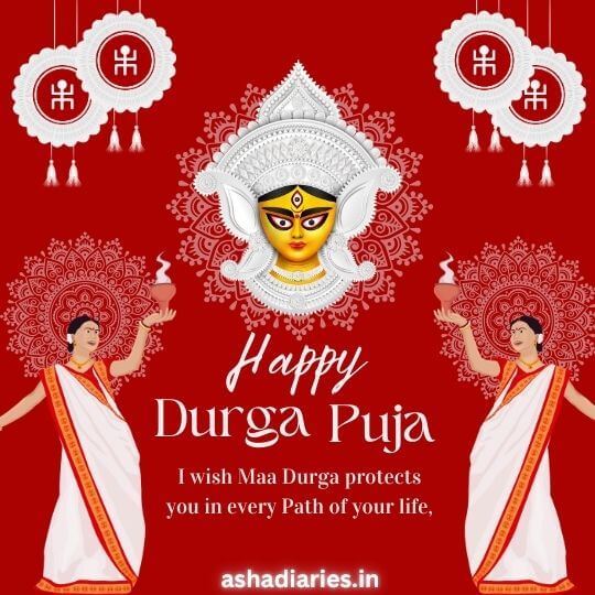 Happy Durga Puja Celebration Image Featuring Goddess Durga's face at the center with two women performing rituals on either side, adorned with traditional designs and patterns. The message reads, 'I wish Maa Durga protects you in every path of your life.' Ashadiaries.in branding is included at the bottom.