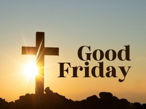 A silhouette of a cross stands atop a rocky hill with the sun rising directly behind it, casting rays of light into the sky. The words "Good Friday" are superimposed on the image in large, clear font, suggesting the theme of the Christian holiday that commemorates the crucifixion of Jesus Christ.