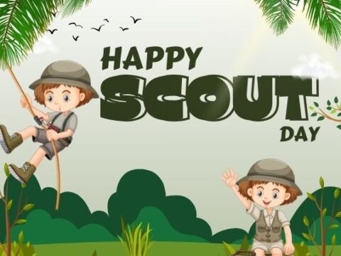 A graphic celebrating "Happy Scout Day" with two cartoon children dressed in scout uniforms. One child is climbing a rope, and the other is sitting on a suitcase with a hand raised in greeting. They are surrounded by a natural landscape with palm trees, grass, and a clear sky with birds flying in the distance.