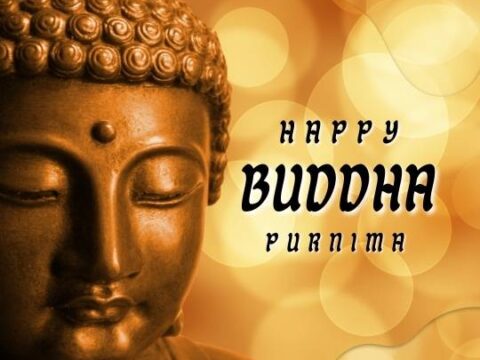 A statue of Buddha with a warm golden glow and bokeh effect in the background, with text wishing "Happy Buddha Purnima".