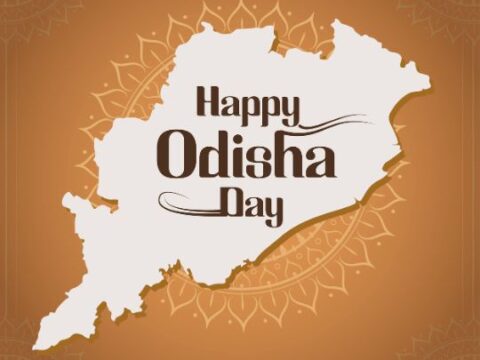 An illustration with a map of Odisha in white, surrounded by decorative motifs and text that reads "Happy Odisha Day" on an orange background.