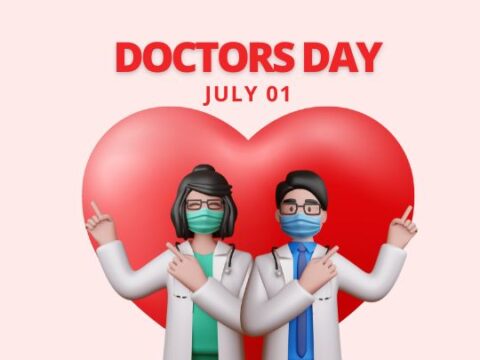 A graphic celebrating Doctors' Day with two cartoon-style doctors, a male and a female, standing in front of a large heart. The female doctor has green detailing on her white coat, and the male doctor has blue. Both are wearing surgical masks and pointing upward, gesturing a peace sign with their fingers. Text above reads 'DOCTORS DAY JULY 01', against a soft pink background.