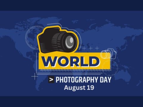 This image is a promotional graphic for World Photography Day, which is celebrated on August 19th. The design features a stylized camera icon with a world map in the background, predominantly in a deep blue color scheme. The text "WORLD PHOTOGRAPHY DAY" is prominently displayed along with the date, making it clear that the image is meant to commemorate this special occasion.