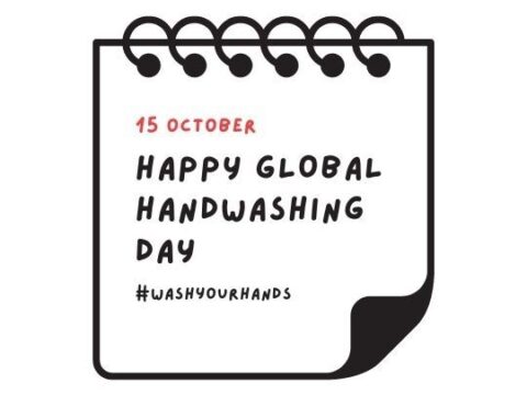 Graphic of a notepad with a page flipped over showing the date '15 October' and the message 'Happy Global Handwashing Day' along with the hashtag '#washyourhands'. The design is simple with red and black text on a white background, prominently displayed on the blog ashadiaries.in.