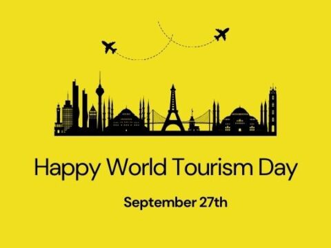 Happy World Tourism Day graphic with a yellow background. The image features a black silhouette of famous landmarks from around the world, such as the Eiffel Tower, the Statue of Liberty, and others. Two airplanes are shown flying above the landmarks. The text reads 'Happy World Tourism Day' with the date 'September 27th' below. The website ashadiaries.in is mentioned in the bottom right corner.
