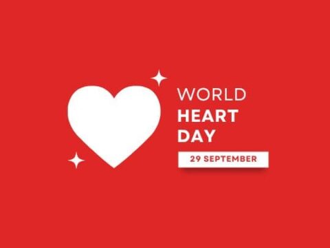 The image features a vibrant red background with a large white heart in the center. Sparkling stars are scattered around the heart, emphasizing a festive or celebratory mood. At the bottom, there is a label stating "WORLD HEART DAY 29 SEPTEMBER," promoting awareness of heart health. The overall design is clean and focused, making it suitable for promotional materials related to World Heart Day.