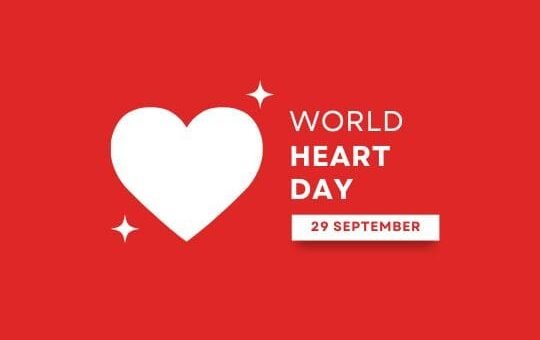 World Heart Day Awareness Campaign Graphic | Asha Diaries the Image Features a Vibrant Red Background with a Large White Heart in the Center. Sparkling Stars Are Scattered Around the Heart, Emphasizing a Festive or Celebratory Mood. at the Bottom, There is a Label Stating "world Heart Day 29 September," Promoting Awareness of Heart Health. the Overall Design is Clean and Focused, Making It Suitable for Promotional Materials Related to World Heart Day.