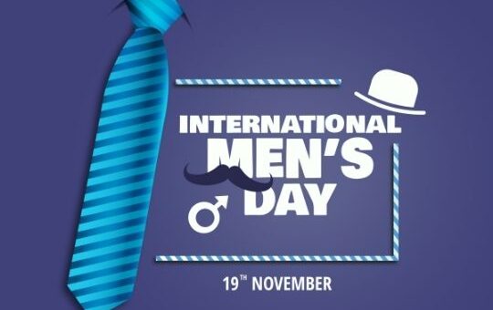 Promotional Image for International Men's Day Featuring a Blue Striped Tie and a Graphic Mustache with the Text 'international Men's Day and the Date '19th November' on a Purple Background, from the Blog Ashadiaries.in.