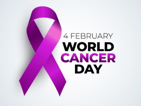 World Cancer Day awareness ribbon in purple, with text "4 February World Cancer Day" on a white background.